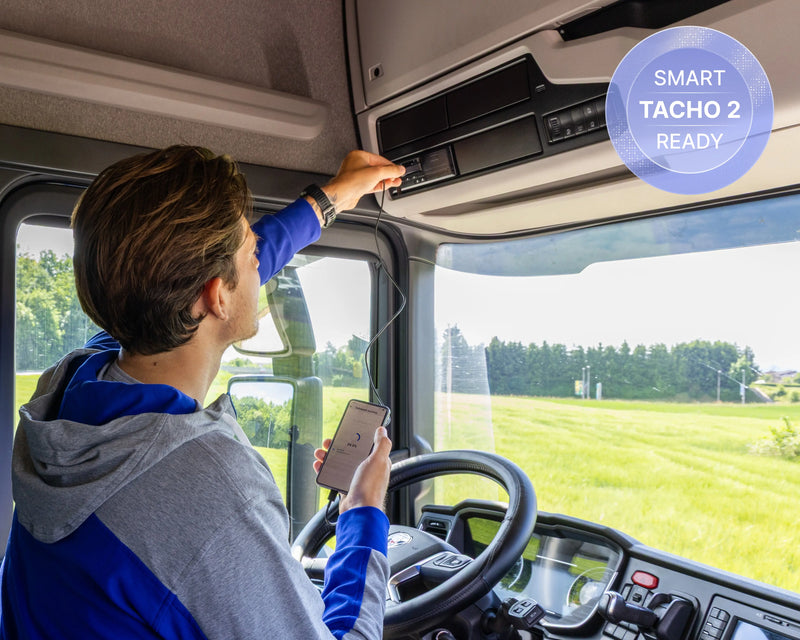Person inside a vehicle using a phone to record a Smart Tacho 2 Ready tachograph.
